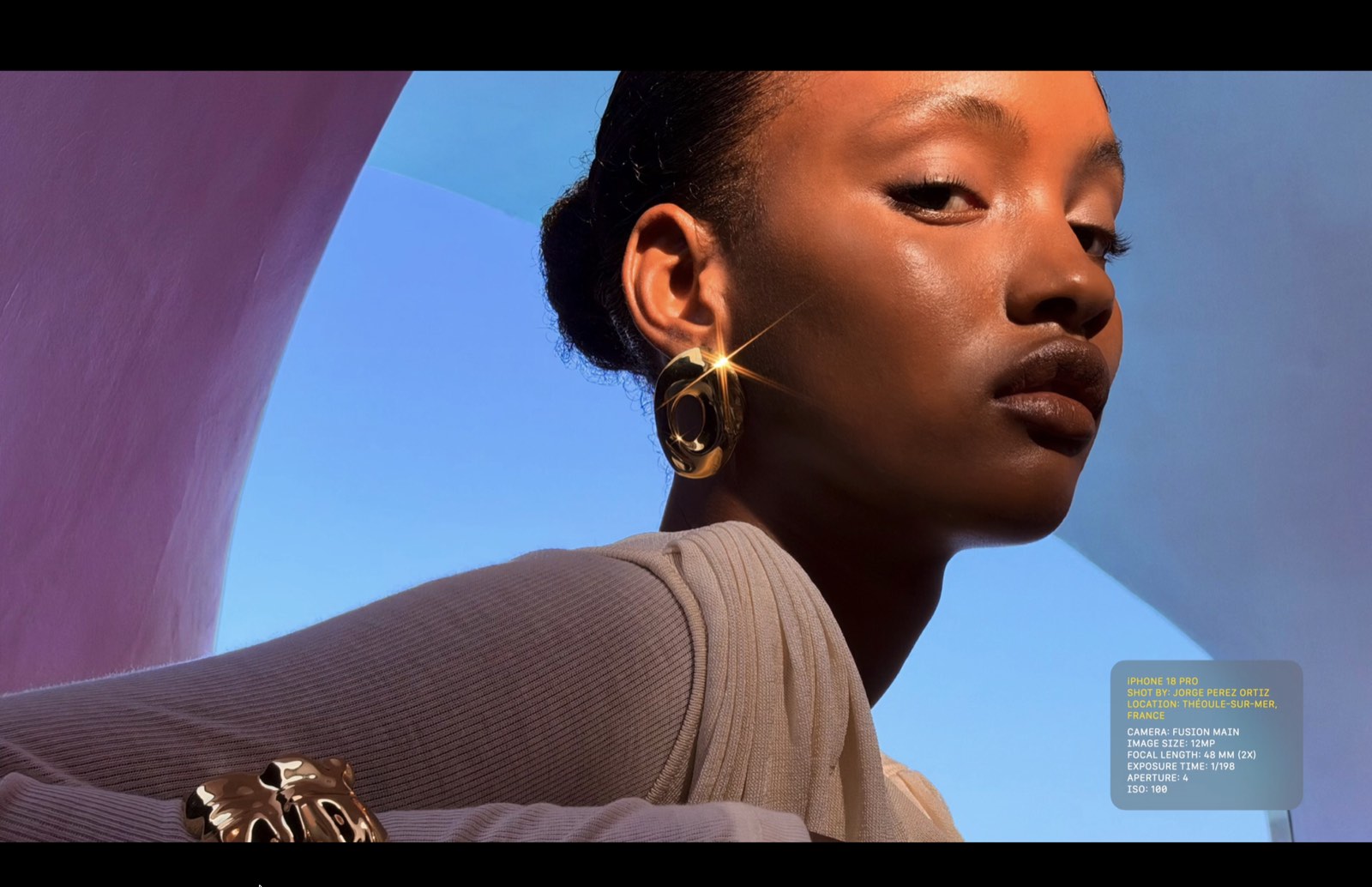 Sunlit portrait with an earring reflection