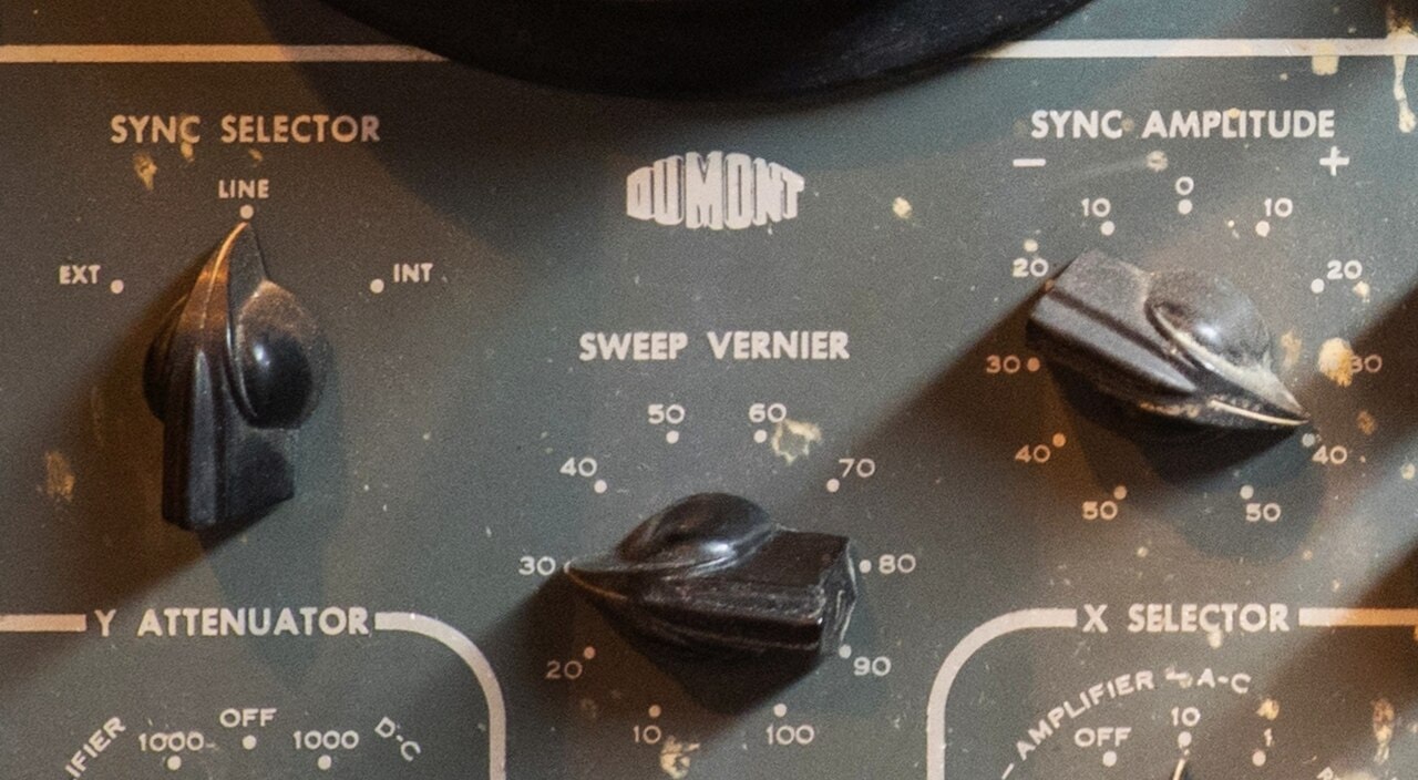 Three black rotary control knobs on the front panel of a vintage DuMont 304 oscilloscope